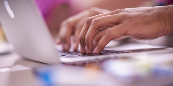 Hand typing on computer