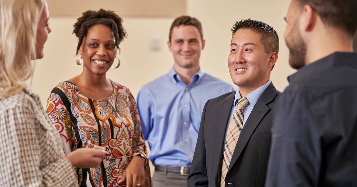 faculty and students talking